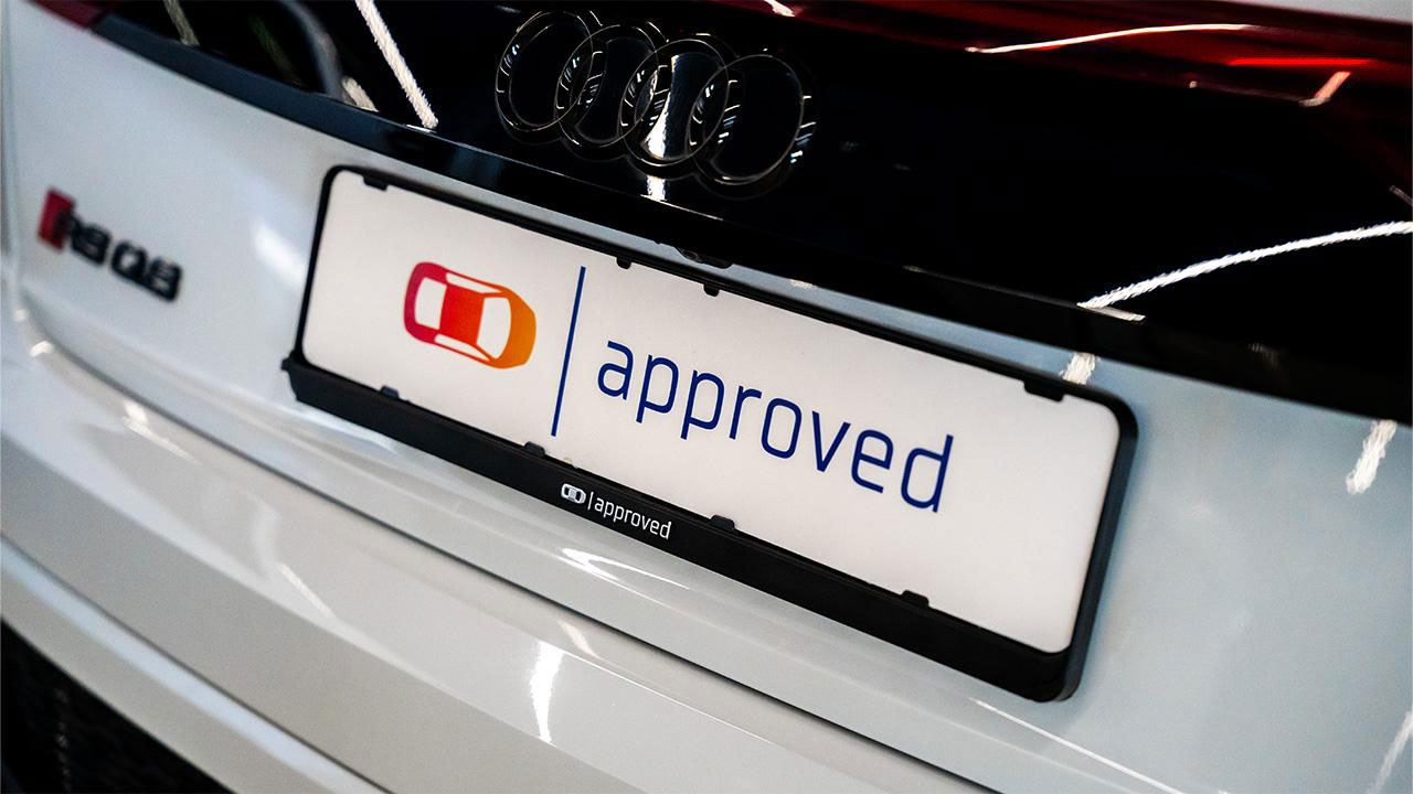 Audi RS Q8 with an Approved-branded showroom plate and holder
